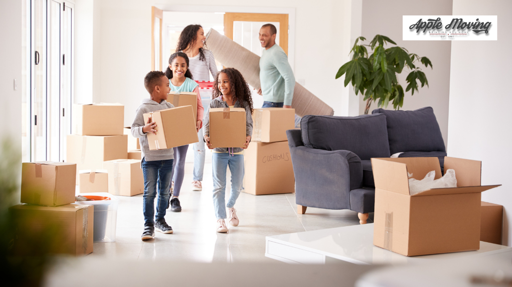 family of four holding boxes