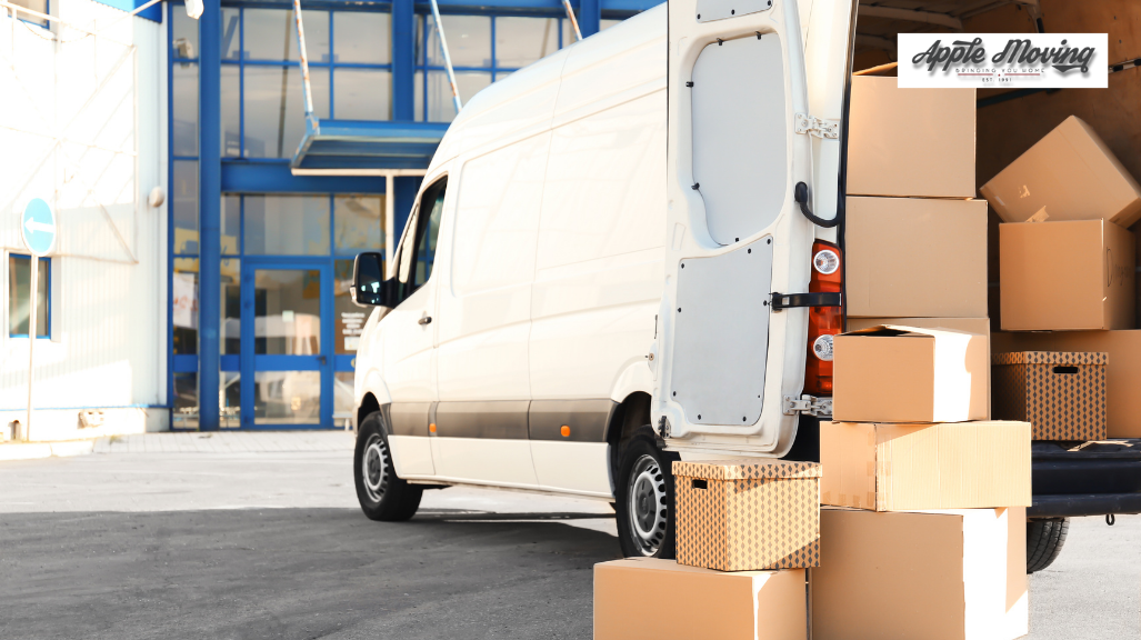 brown cardboard box lot behind white cargo van